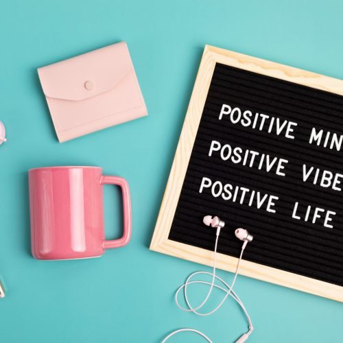Positive mind, vibes, life motivational quote on the letter board. Inspiration text. Top view of the desktop