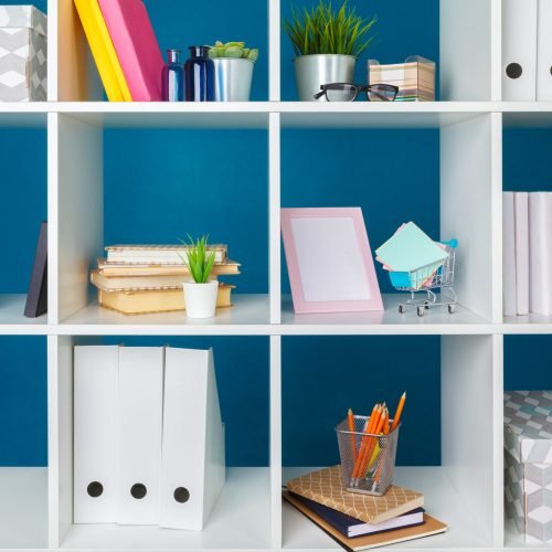 Stacks of supplies and paperwork in the office and bookshelves